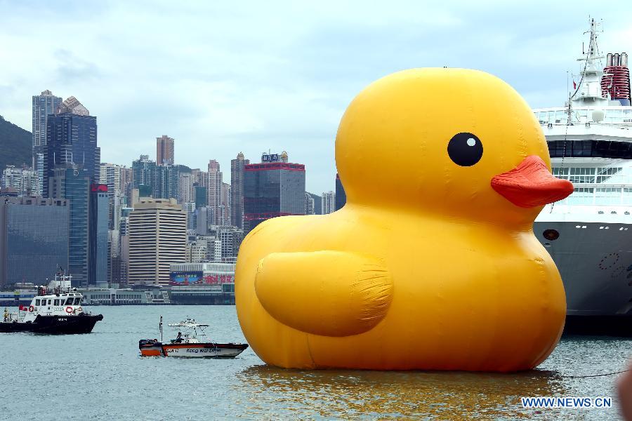 A huge rubber duck floats on the waters at the Victoria Harbor in Hong Kong, south China, May 2, 2013. The largest rubber duck was created by Dutch artist Florentijn Hofman, with 18 meters of length, 15 meters of width and height. The duck has visited 12 cities since 2007. (Xinhua/Li Peng)