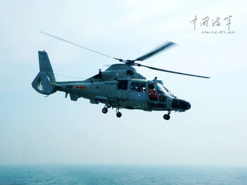 A ship-borne helicopter is in anti-submarine drills in the Yellow Sea under complicated weather conditions. (China Military Online)