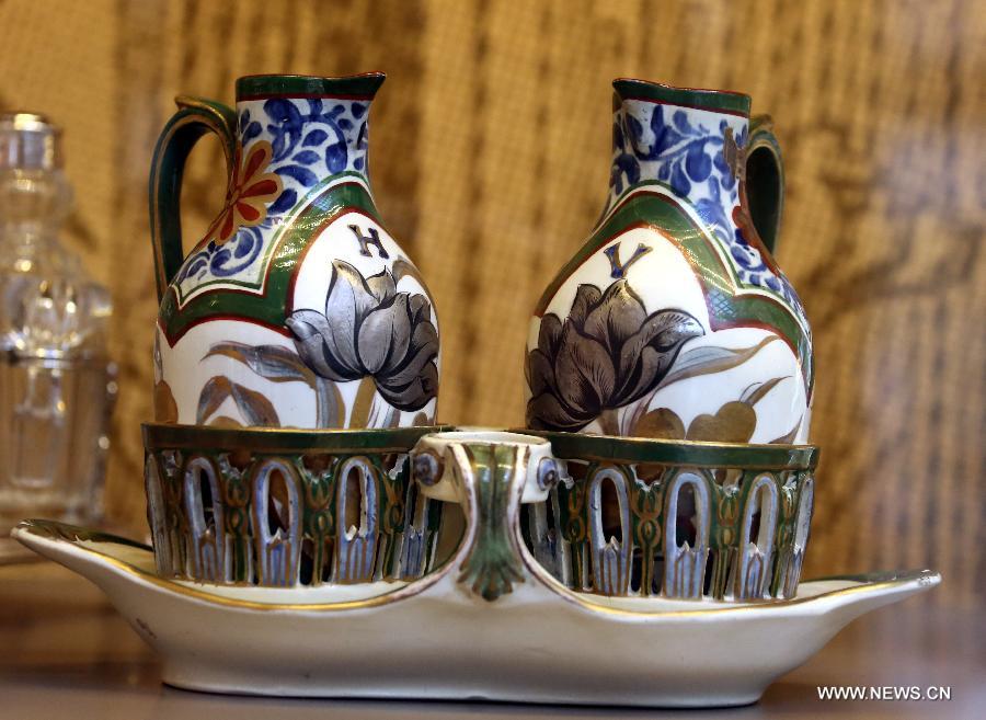 Photo taken on May 4, 2013 shows coloured pottery kettles made in the 19th century displayed in an exhibition of "Splendour of the French Table" in Hong Kong, south China. As one of the activities of "French May", the exhibition which will last till June 9 presents tableware from leading French historical manufactures and luxury maisons since the 18th century. (Xinhua/Li Peng) 