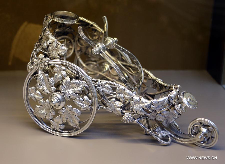 Photo taken on May 4, 2013 shows a 19th century silvering object carrying wines displayed in an exhibition of "Splendour of the French Table" in Hong Kong, south China. As one of the activities of "French May", the exhibition which will last till June 9 presents tableware from leading French historical manufactures and luxury maisons since the 18th century. (Xinhua/Li Peng) 