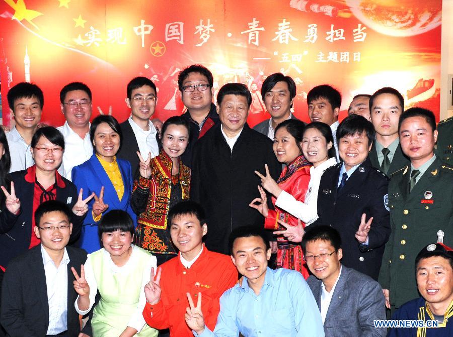 Chinese President Xi Jinping (C) poses for a photo with representatives of model youth before joining a discussion to mark the country's Youth Day on Saturday at China Academy of Space Technology in Beijing, capital of China, May 4, 2013. Xi on Saturday called on Chinese young people to contribute to the revitalization of the nation and "hone themselves at grassroots." (Xinhua/Rao Aimin)