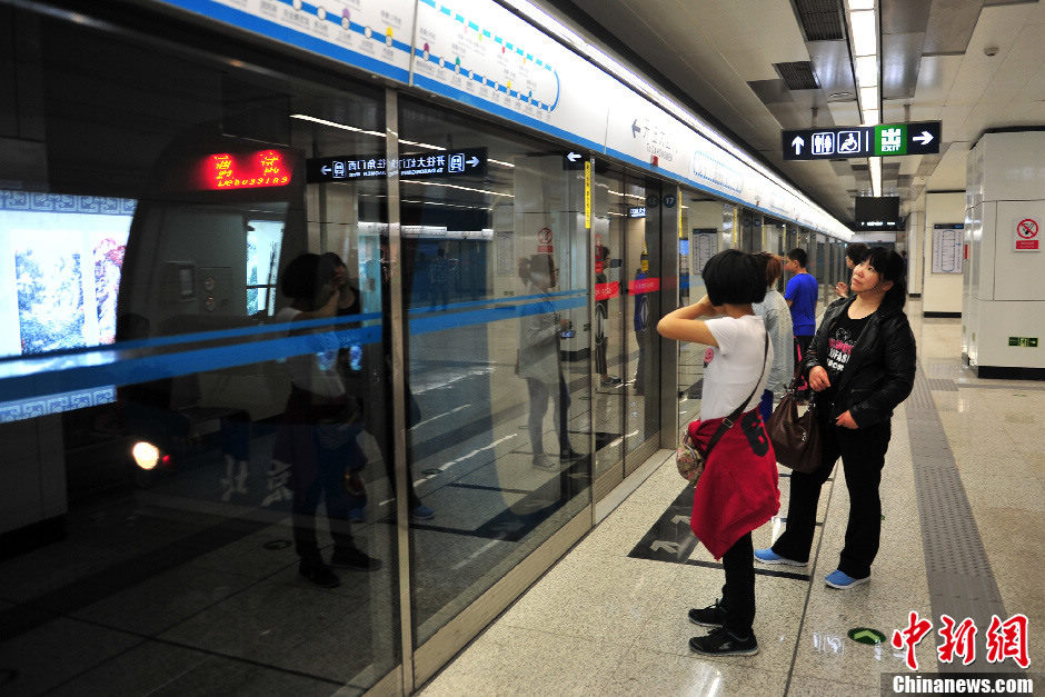 Passengers take Beijing Subway Line 10 on May 5, 2013. The last three stations were opened to complete the city's second loop subway line on Sunday. With 45 stations, the 57-kilometer line takes 104 minutes to make a complete loop, which makes it the longest completely underground subway line in the world.[Photo/CNS]