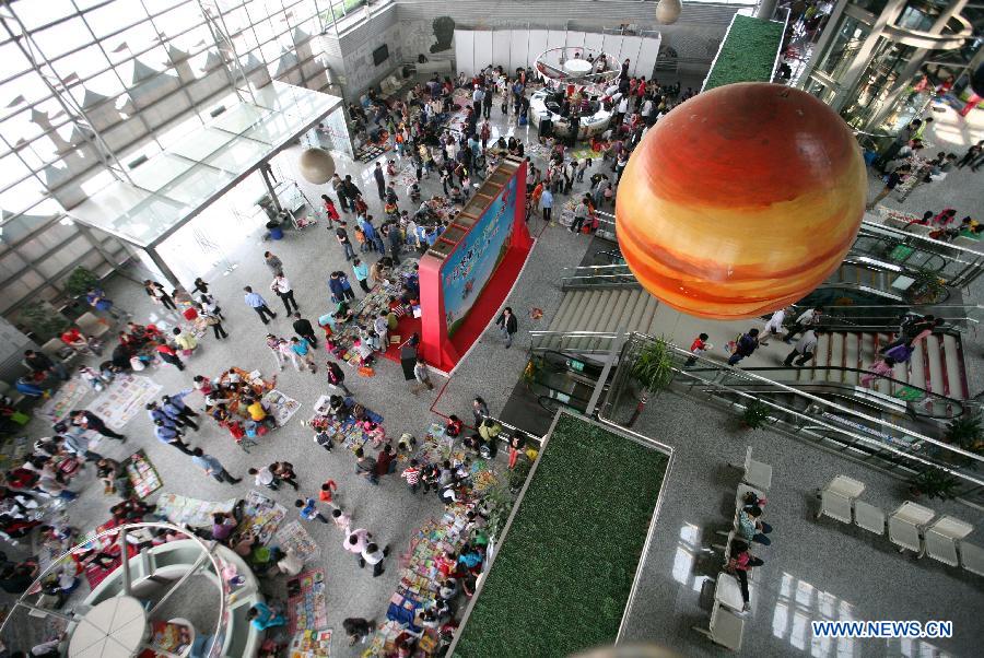 A secondhand book fair is held in Nanjing, capital of east China's Jiangsu Province, May 5, 2013. During the fair, pupils and middle school students could sell or exchange their idle books, stationery and toys as well, by which they were expected by the organizer to learn a frugal lifestyle. (Xinhua/Wang Xin)