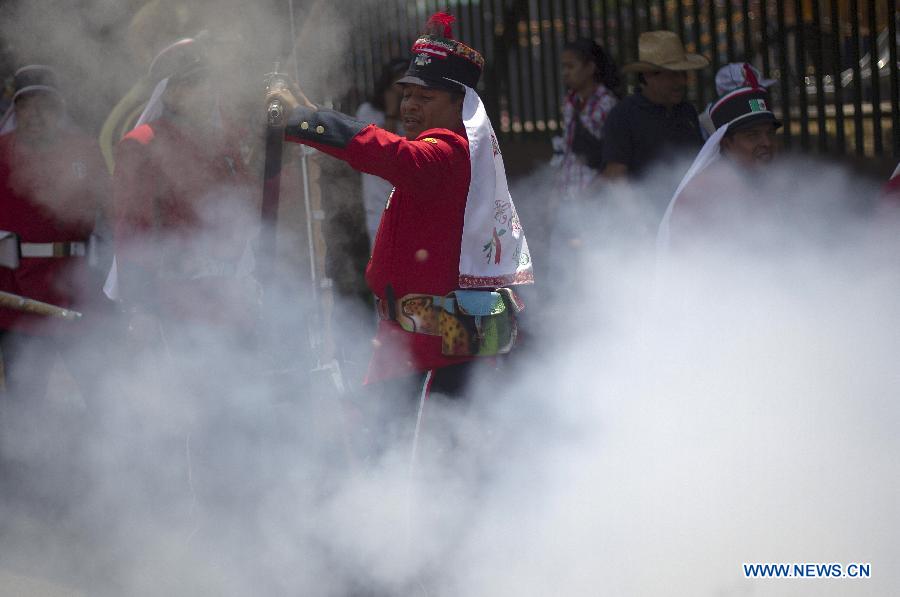 A resident dressed as soldier participates in the celebrations of 151st anniversary of the Battle of Puebla, at the Penon de los Banos neighborhood, in Mexico City, capital of Mexico, on May 5, 2013. The Battle of Puebla took place on May 5, 1862 near the city of Puebla during the French intervention in Mexico. The Mexican victory is celebrated yearly on May 5. (Xinhua/Alejandro Ayala) 