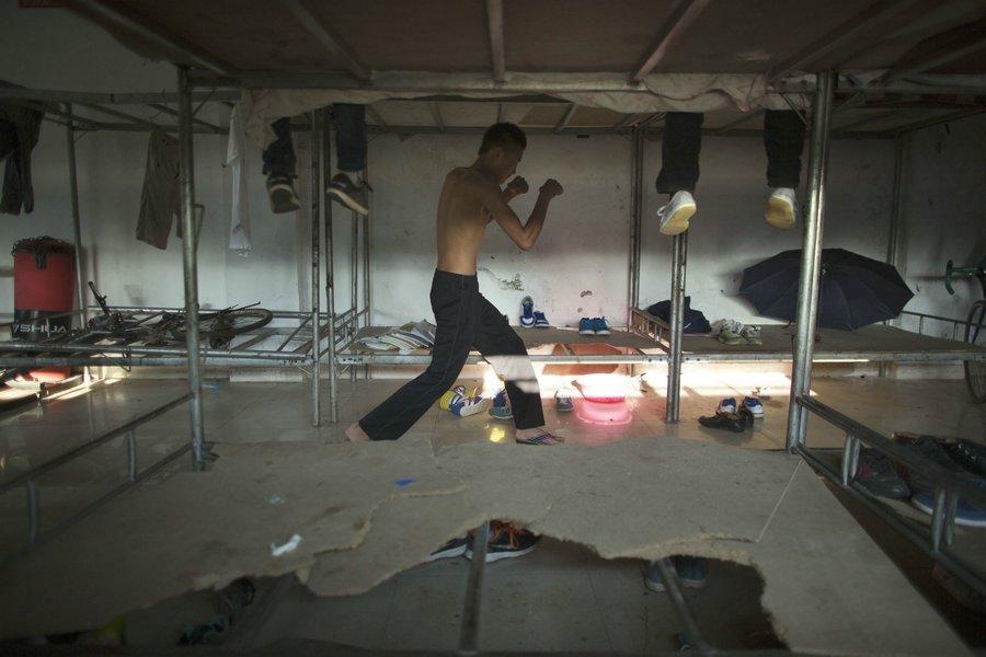 After physical training, Huang Bo, 16, continues to practice in the dorm, April 17, 2013. (Xinhua/Fei Maohua)