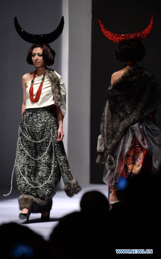 Models present traditional ethnic fashion creations during the 2013 China (Qingdao) International Fashion Week in Qingdao, a coastal city in east China's Shandong Province, May 5, 2013. (Xinhua/Li Ziheng) 