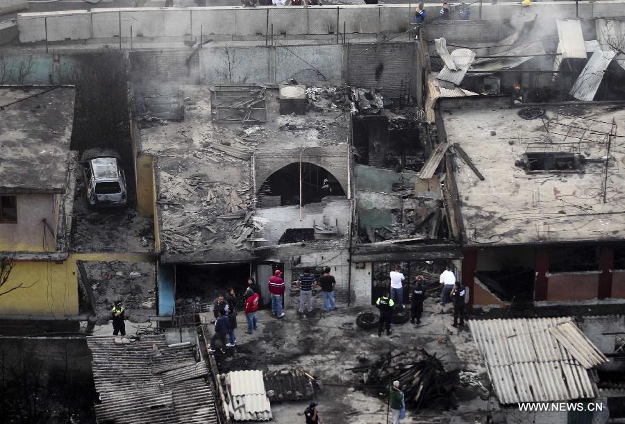 Firemen and Police work at the site of an explosion on the Mexico-Pachuca highway in Ecatepec, Mexico, on May 7, 2013. At least 18 people were killed and dozens of others injured when a gas tanker exploded early Tuesday in a Mexico City suburb, authorities said. (Xinhua/Susana Martinez) 