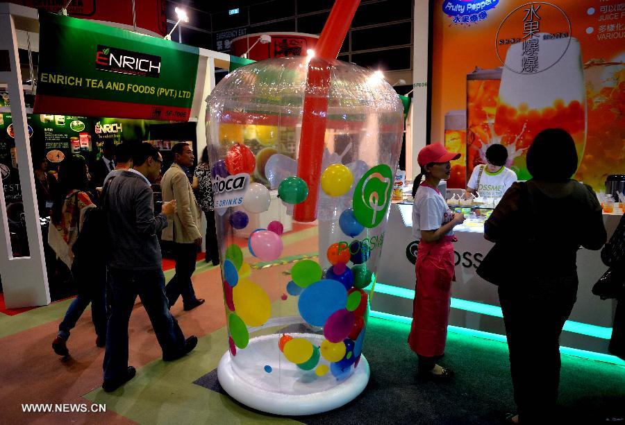 People visit the drinks exhibition area of the 15th International Exhibition of Food & Drink, Hotel, Restaurant & Food Service Equipment, Supplies & Services (HOFEX) in south China's Hong Kong, May 7, 2013. The four-day HOFEX 2013 kicked off on Tuesday at Hong Kong Convention & Exhibition Center. (Xinhua/Chen Xiaowei)