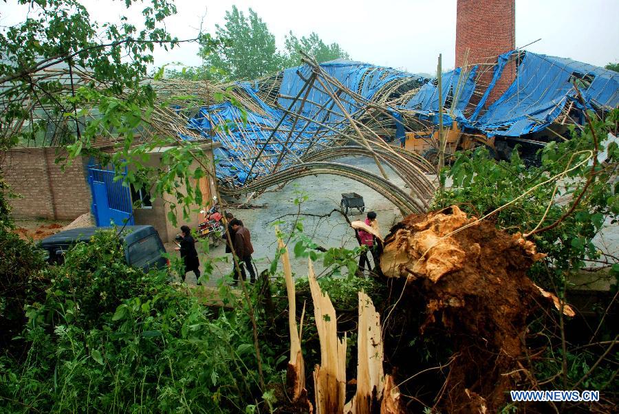 The shed of a chemical company is damaged by hails and storms at Maogoubao Village of Fuquan City, southwest China's Guizhou Province, May 7, 2013. The central, south central and southeast parts of Guizhou were hit by hails and storms from Monday to Tuesday, disturbing local traffic and power service and causing damage to agricultural production. (Xinhua/Wu Rubo)