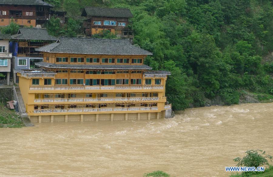 Photo taken on May 7, 2013 shows a flooded building at Jidao Miao Village of Kaili City, southwest China's Guizhou Province. The central, south central and southeast parts of Guizhou were hit by hails and storms from Monday to Tuesday, disturbing local traffic and power service and causing damage to agricultural production. (Xinhua/Chen Peiliang)
