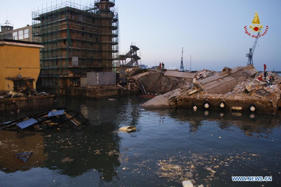 This photo released by Italian Vigili del Fuoco (Italian fire service) shows rescue workers inspecting the debris of the collapsed control tower at north Italy's Genoa port on May 8, 2013. The death toll of the Italian ship's accident in the northern Genoa port rose to seven late on Wednesday while more were injured or missing. Divers were still searching bodies trapped in the underwater rubble of a 50-meter-tall control tower that was demolished by the container ship Jolly Nero on Tuesday night. The ship, 239 meters long and with a gross tonnage of nearly 40,600 tonnes, suddenly crashed into the concrete and glass tower while maneuvering out the port in calm conditions. (Xinhua/Italian Vigili del Fuoco)