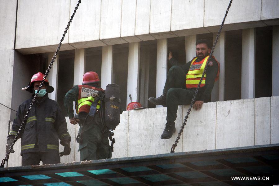 Rescuers work at the LDA Plaza in Lahore, eastern Pakistan. Fire erupted on the seventh floor of the LDA Plaza in Lahore and quickly spread to higher floors, leaving many people trapped inside the building. At least three people fell from the high floors trying to avoid the fire that engulfed the building, local media reports. (Xinhua/Jamil Ahmed)