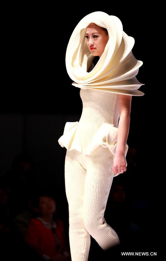 A model presents a fashion creation during the final of a knitting fashion design contest in Qingdao, a coastal city in east China's Shandong Province, May 7, 2013. (Xinhua/Liang Xiaopeng) 