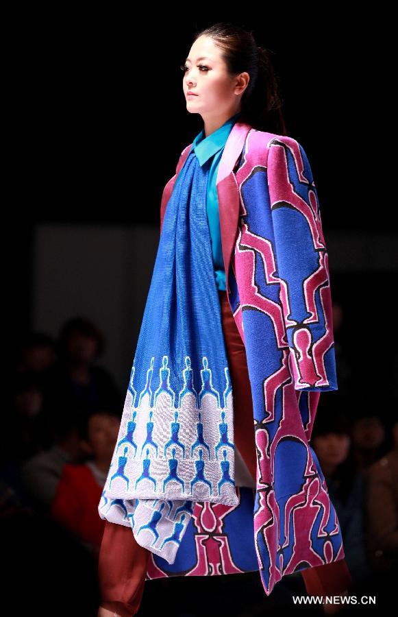 A model presents a fashion creation during the final of a knitting fashion design contest in Qingdao, a coastal city in east China's Shandong Province, May 7, 2013. (Xinhua/Liang Xiaopeng) 