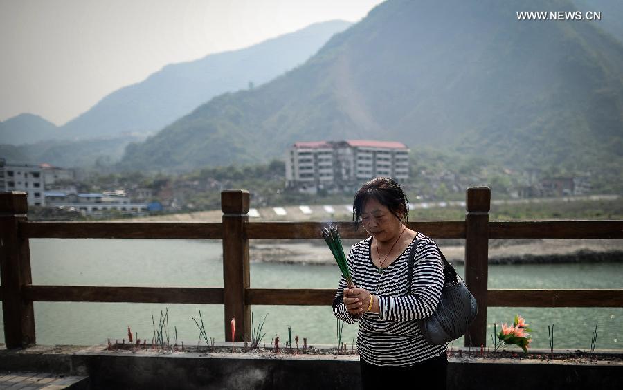 A woman mourns for deceased family members in the Wenchuan Earthquake in Beichuan County, southwest China's Sichuan Province, May 11, 2013. Many people returned to the Beichuan county to mourn for the dead as Sunday marks the fifth anniversary of the 8-magnitude quake that rocked Sichuan Province in 2008. (Xinhua/Jiang Hongjing) 