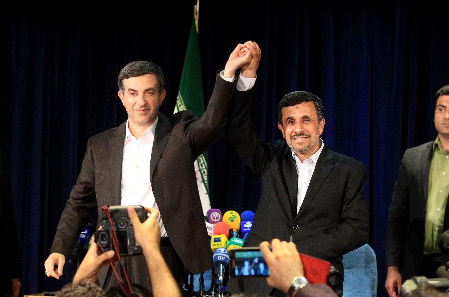 Iranian President Mahmoud Ahmadinejad (R) holds hands with his top aide Esfandiar Rahim-Mashaei during a press conference after Rahim-Mashaei registered for Iran's 11th presidential election at the Interior Ministry in Tehran on May 11, 2013. (Xinhua/Ahmad Halabisaz) 
