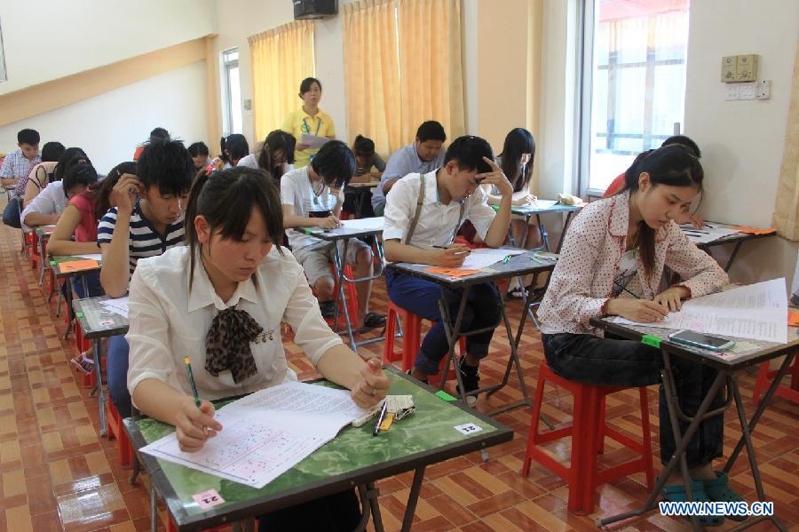 Candidates take an examination of HSK in Mandalay, Myanmar, on May 12, 2013. A Hanyu Shuiping Kaoshi, known as HSK or a proficiency test on Chinese language for non-native speakers, was held for the first half of 2013 in Northern Myanmar where 1281 candidates entered for the test. (Xinhua/Hou Baoqiang) 