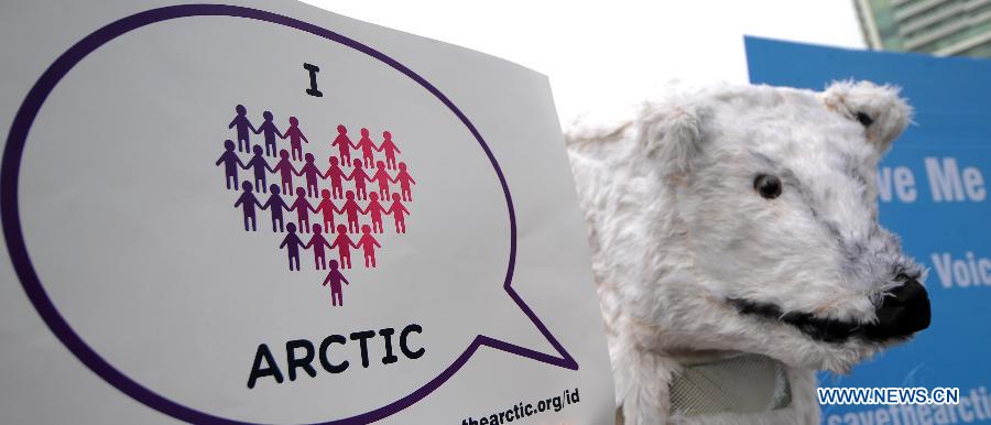 An activist in polar bear costume stands next to a placard during an Arctic-saving campaign in Jakarta, Indonesia, May 12, 2013. The reduction in Arctic summer ice cover registered a record low of 3.4 million square kilometers in 2012, which was 18 percent below the previous recorded minimum in 2007 and 50 percent below the average in the 1980s and 1990s, stated the UN Environment Program (UNEP). (Xinhua/Veri Sanovri)