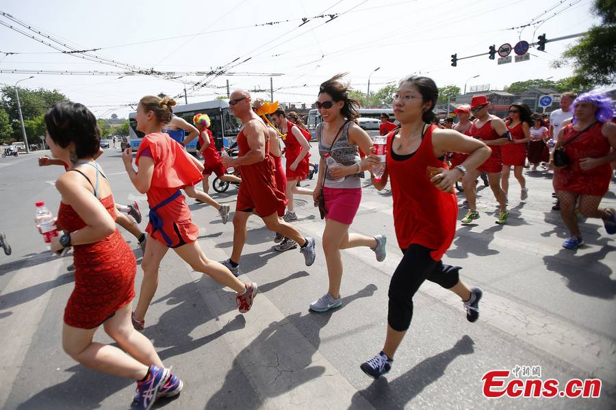 Hundreds of women – and especially men in their red dresses participate in the Red Dress Run in Beijing, May 12, 2013. (CNS/Fu Tian)