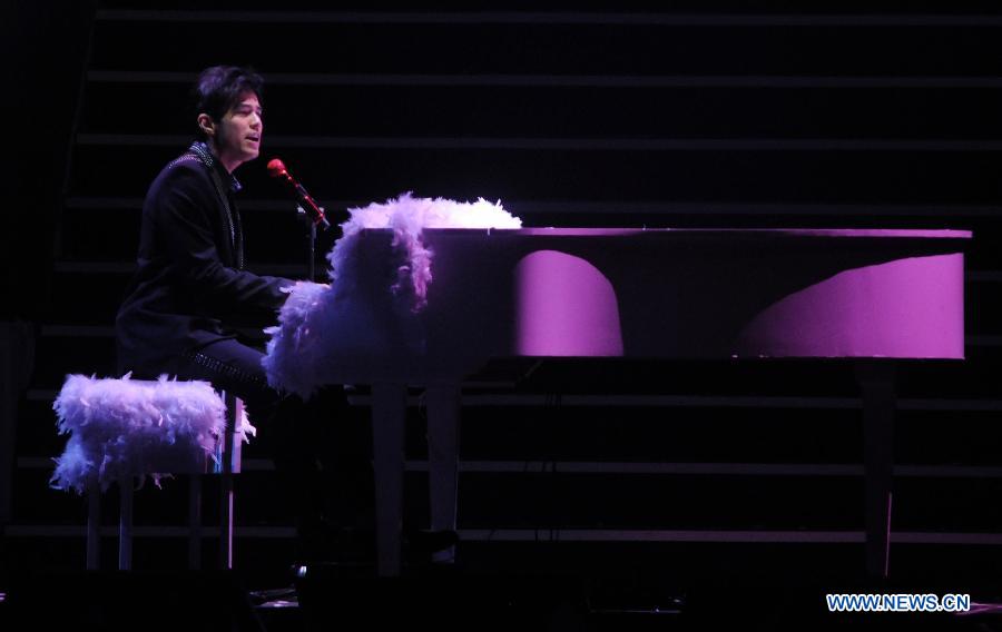 Singer Jay Chou performs during a memorial concert for Teresa Teng held in the Taipei Arena in Taipei, southeast China's Taiwan, May 12, 2013. The concert marks the 18th anniversary of the death and 60th anniversary of the birth of Teresa Teng (1953-1995), one of the most famous pop singers in China. (Xinhua/Wu Ching-teng)