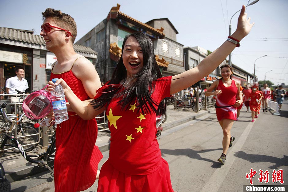 Hundreds of foreign and local runners participated in Run Dress Run at Beijing's Shishahai on Sunday. Red Dress Run originated in Indonesia, with runners wearing various red dresses to promote running. It aims to tell people that running is an easy sport, and one can even run in skirt. (CNS/ Fu Tian)