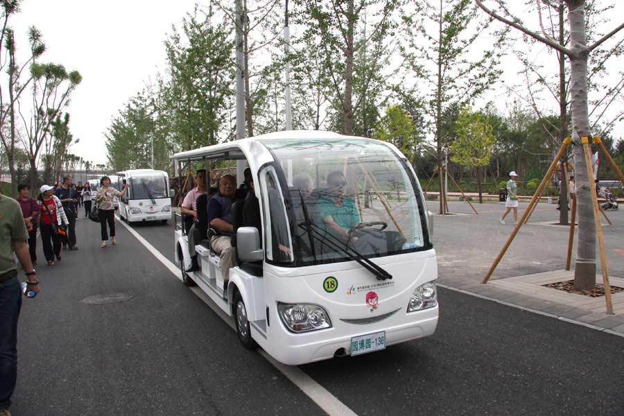 Visitors travel in electric cars in the Ninth China (Beijing) International Garden Expo during the expo's trial run on Monday, May 13, 2013. The expo covers an area of 513 hectares, including 267-hecare public exhibition area and 246-hectare Garden Expo Lake. The event will officially kick off on May 18, 2013 and last for six months. (CRIENGLISH.com/Luo Dan)