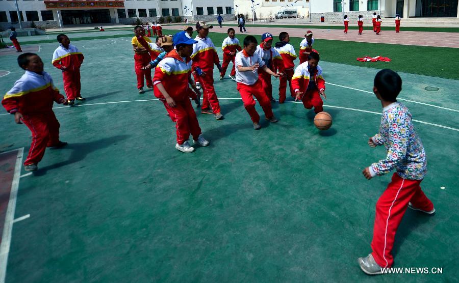 Orphan students take physical exercise class at the Bayi Orphan School in Yushu Tibet Autonomous Prefecture in northwest China's Qinghai Province, May 13, 2013. The school is now a home of 323 orphan students who are instructed and cared by 57 teachers. (Xinhua/Wang Bo)