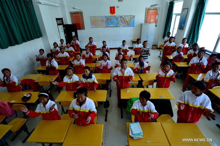 Orphan students of the third grade take music class at the Bayi Orphan School in Yushu Tibet Autonomous Prefecture in northwest China's Qinghai Province, May 13, 2013. The school is now a home of 323 orphan students who are instructed and cared by 57 teachers. (Xinhua/Wang Bo)