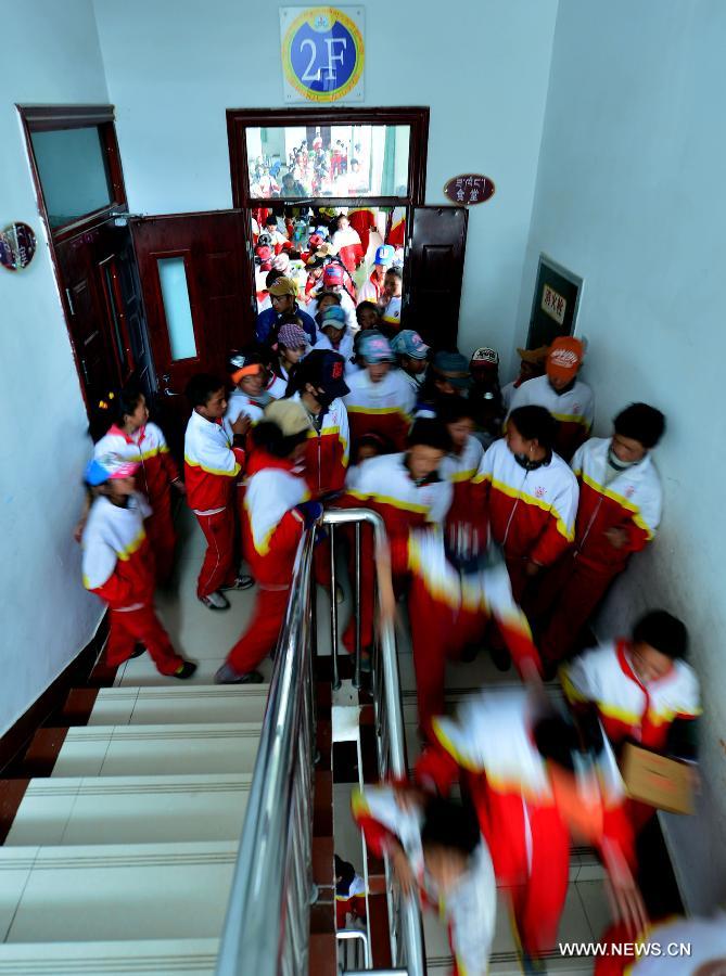 Orphan students walk out of a dining hall after supper at the Bayi Orphan School in Yushu Tibet Autonomous Prefecture in northwest China's Qinghai Province, May 13, 2013. The school is now a home of 323 orphan students who are instructed and cared by 57 teachers. (Xinhua/Wang Bo)