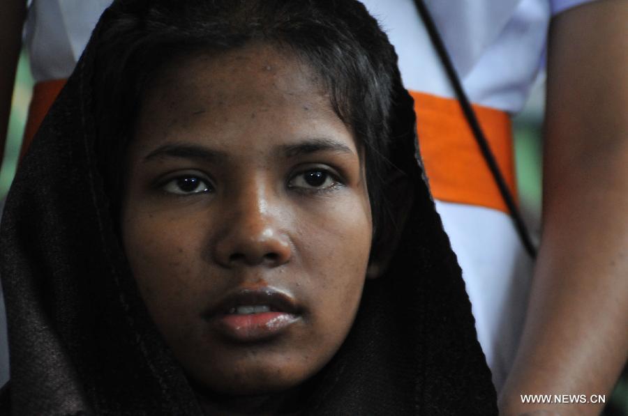 Reshma, a young female garment worker, meets with the media at a hospital in Savar on the outskirts of Dhaka, Bangladesh, May 13, 2013. Sixteen days after Bangladesh's worst-ever industrial tragedy, rescuers found Reshma who is clinging to life beneath the sandwiched floors of the collapsed eight-storey building. (Xinhua/Shariful Islam)