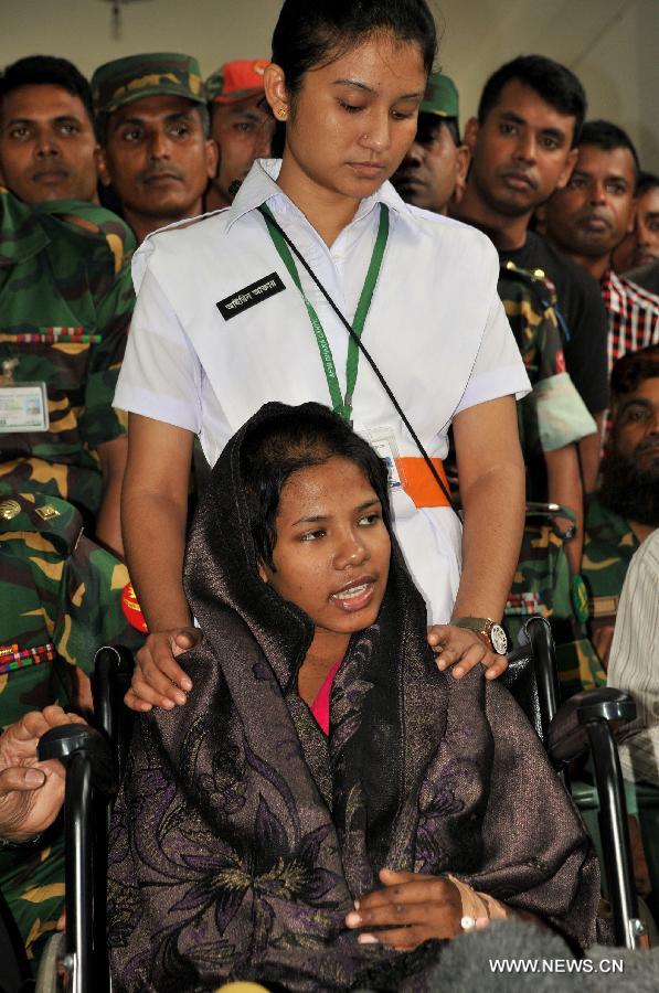 Reshma (front), a young female garment, worker meets with the media at a hospital in Savar on the outskirts of Dhaka, Bangladesh, May 13, 2013. Sixteen days after Bangladesh's worst-ever industrial tragedy, rescuers found Reshma who is clinging to life beneath the sandwiched floors of the collapsed eight-storey building. (Xinhua/Shariful Islam)