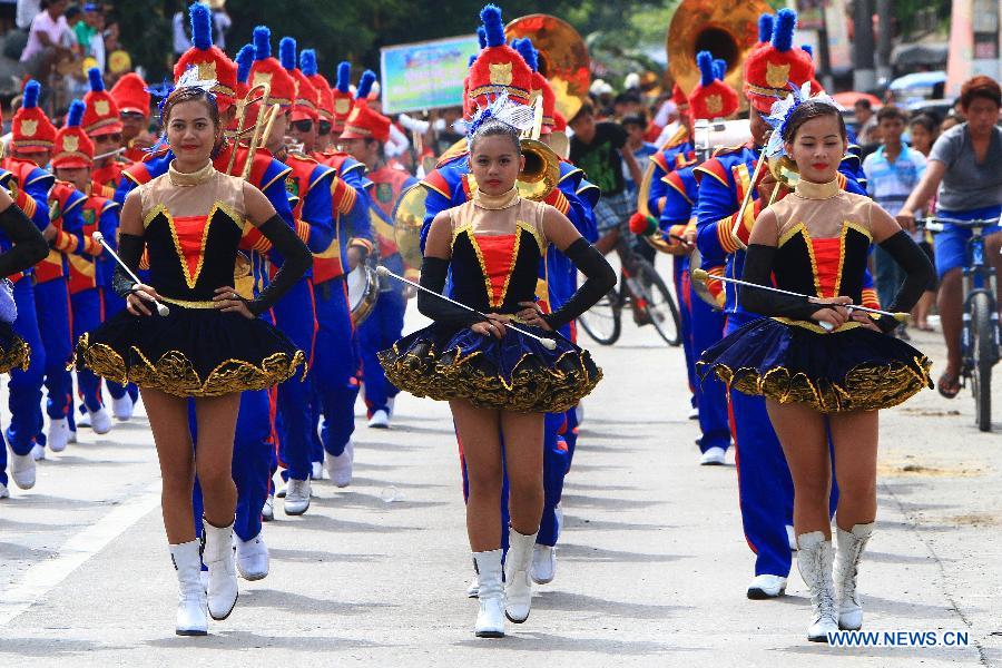 A parade band marches during the traditional Carabao Festival in Bulacan Province, the Philippines, May 14, 2013. A procession of more than 600 water buffalos, locally known as carabaos, with decorated carts paraded on street during the annual Carabao Festival. (Xinhua/Rouelle Umali)