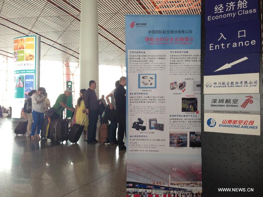 Passengers check in at Capital International Airport in Beijing, capital of China, May 15, 2013. Three Chinese airlines were targeted by false bomb threats Wednesday morning. Five flights operated by China Eastern Airlines, Juneyao Airlines and Shenzhen Airlines were affected. (Xinhua) 