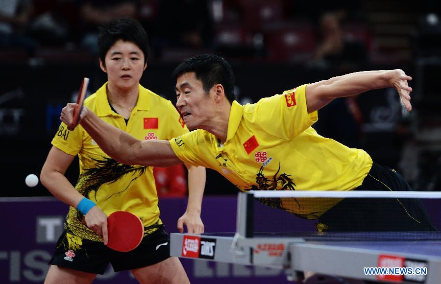 Wang Liqin (R) and Rao Jingwen of China compete during round of 64 of mixed doubles match against Robert Floras and Monika Pietkiewicz of Poland at Palais omnisport de Paris Bercy in Paris, France, on May 15, 2013. Wang Liqin and Rao Jingwen won 4-1. (Xinhua/Tao Xiyi)