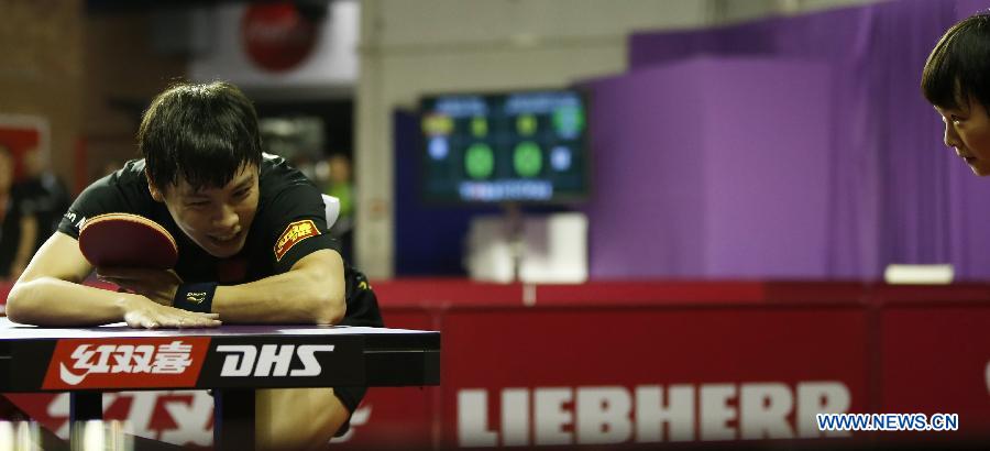 Chen Qi and Hu limei (R) of China react during round of 64 of mixed doubles match against Steffen Mengel and Sabine Winter of Germany at Palais omnisport de Paris Bercy in Paris, France, on May 15, 2013. Chen Qi and Hu Limei won 4-3. (Xinhua/Wang Lili)