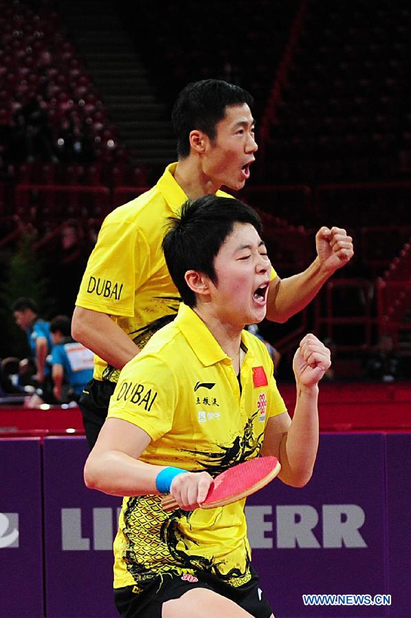 Wang Liqin (Back) and Rao Jingwen of China celebrate after scoring during round of 64 of mixed doubles match against Robert Floras and Monika Pietkiewicz of Poland at Palais omnisport de Paris Bercy in Paris, France, on May 15, 2013. Wang Liqin and Rao Jingwen won 4-1. (Xinhua/Tao Xiyi)