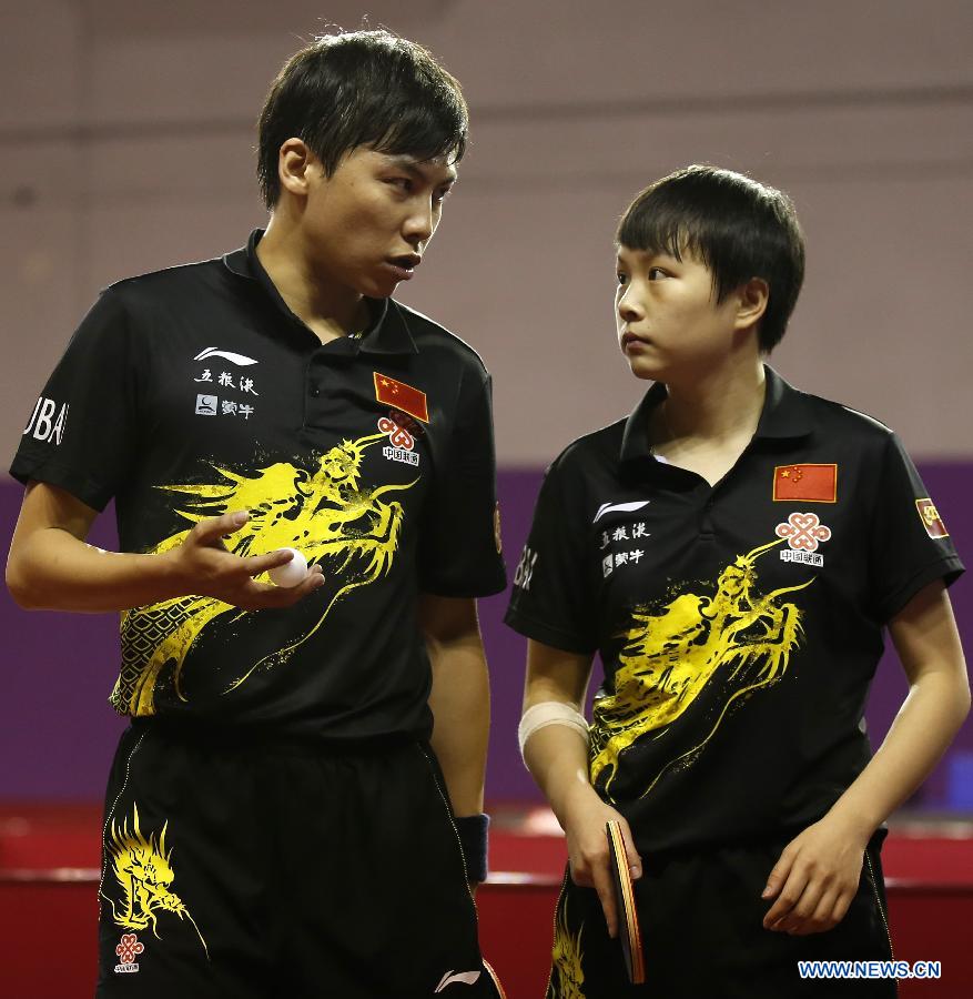 Chen Qi and Hu limei (R) of China react during round of 64 of mixed doubles match against Steffen Mengel and Sabine Winter of Germany at Palais omnisport de Paris Bercy in Paris, France, on May 15, 2013. Chen Qi and Hu Limei won 4-3. (Xinhua/Wang Lili)