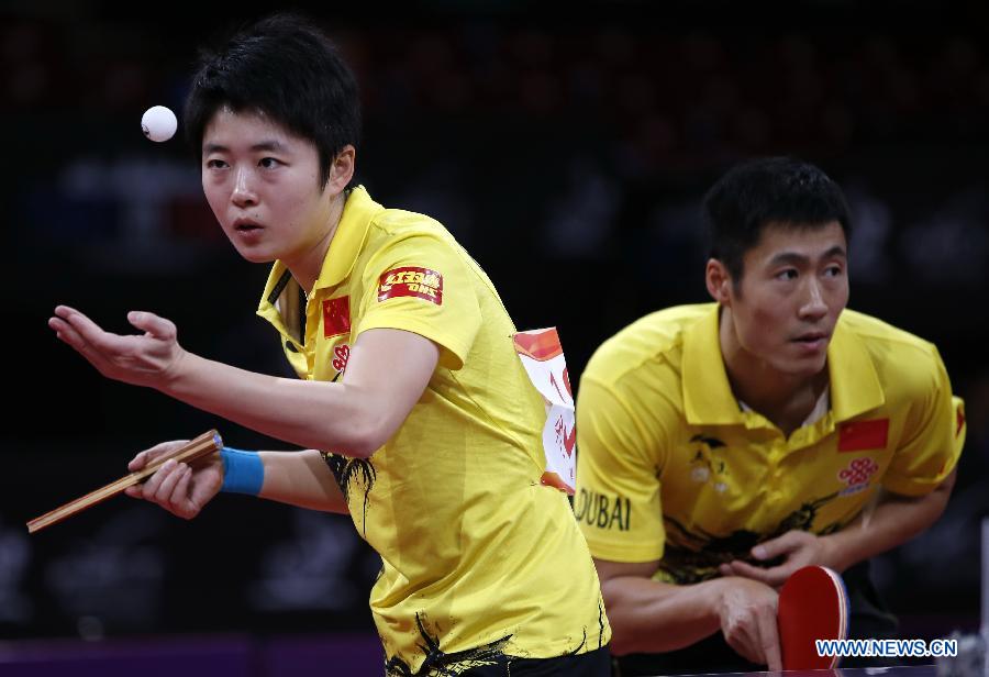 Wang Liqin (R) and Rao Jingwen of China compete during round of 64 of mixed doubles match against Robert Floras and Monika Pietkiewicz of Poland at Palais omnisport de Paris Bercy in Paris, France, on May 15, 2013. Wang Liqin and Rao Jingwen won 4-1. (Xinhua/Wang Lili)