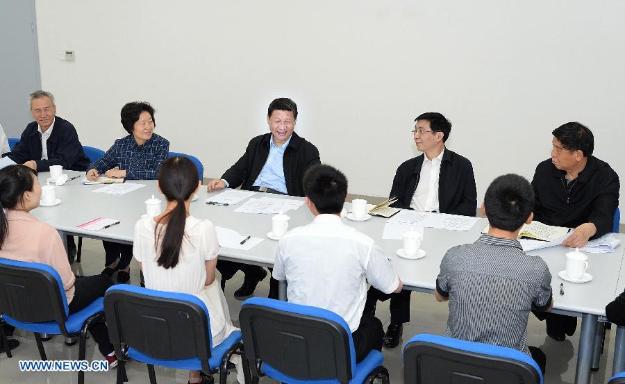 Chinese President Xi Jinping (C, back), talks with representatives of college graduates, the unemployed and rural surplus labor force at the China Tianjin Public Vocational Training Center in north China's Tianjin Municipality. Xi Jinping made an inspection tour to Tianjin from May 14 to 15. (Xinhua/Li Tao)