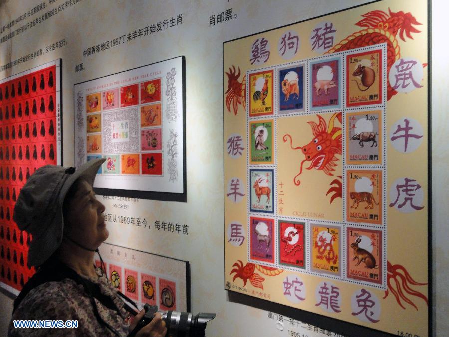 A visitor appreciates zodiac stamps in the Suzhou Zodiac Stamp Museum in Suzhou, east China's Jiangsu Province, May 15, 2013. The museum, which will be opened to the public free of charge on May 18, stores zodiac stamps which were issued in more than 100 countries and regions since 1950. (Xinhua/Wang Jiankang)