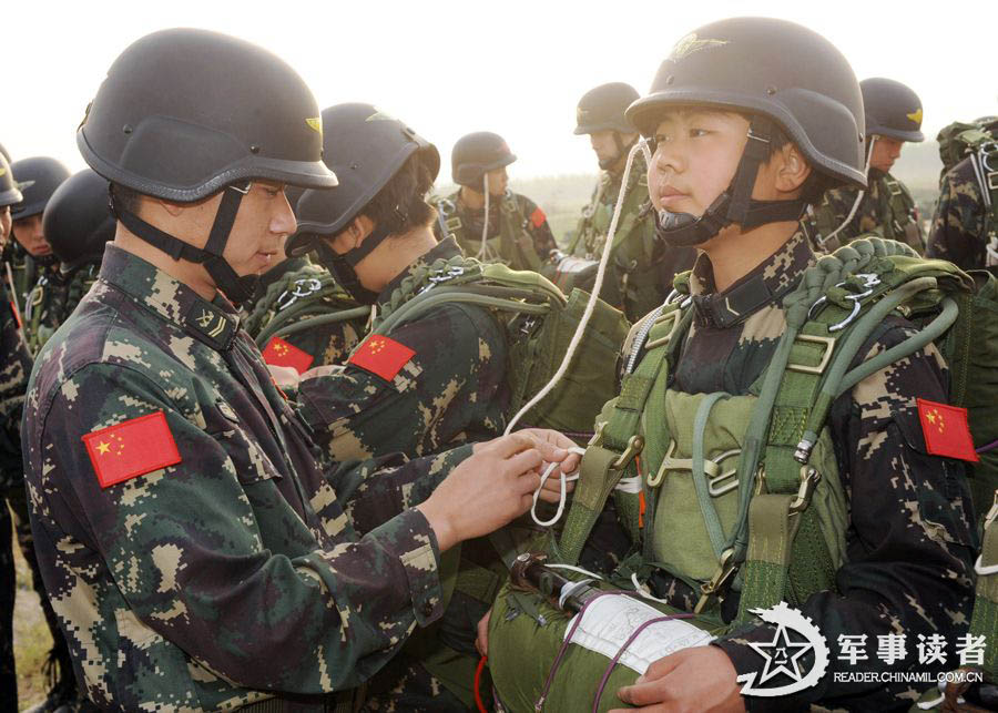 The members from the first female special operation company of the Army of the Chinese People's Liberation Army (PLAA) are in their first parachute landing training on May 14, 2013. (China Military Online/Cheng Jianfeng, Yan Xingxing)