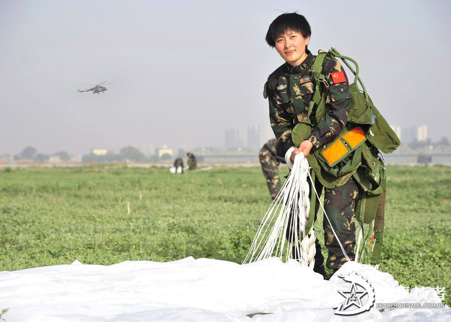 A member from the first female special operation company of the Army of the Chinese People's Liberation Army (PLAA) are in their first parachute landing training on May 14, 2013. (China Military Online/Cheng Jianfeng, Yan Xingxing)