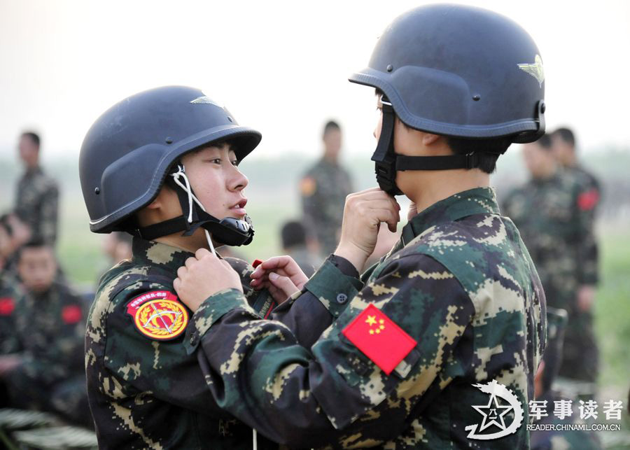 The members from the first female special operation company of the Army of the Chinese People's Liberation Army (PLAA) are in their first parachute landing training on May 14, 2013. (China Military Online/Cheng Jianfeng, Yan Xingxing)