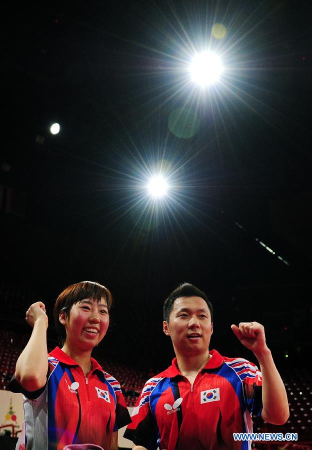 Cho Eonroe (R) and Yang Ha-eun of South Korea celebrate after the round of 16 of mixed doubles against Chen Qi and Hu Limei (R) of China at the 2013 World Table Tennis Championships in Paris, France on May 16, 2013. Cho Eonroe and Yang Ha-eun won 4-3. (Xinhua/Tao Xiyi)