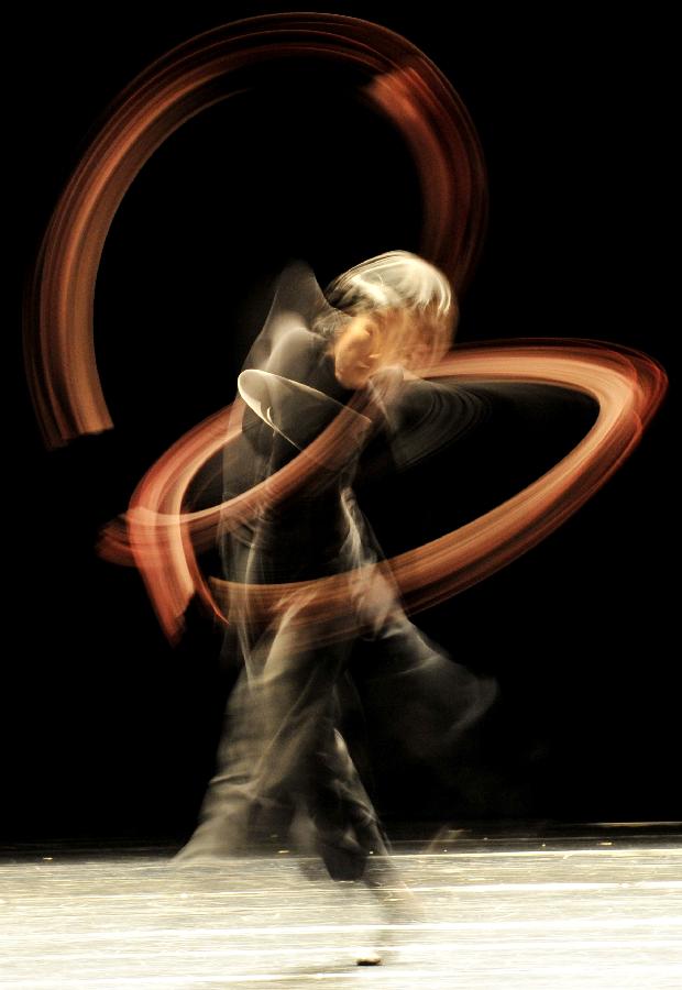 This photo taken on slow shutter speed shows dancers performing "Mirror and Music" which is created by Japanese Saburo Teshigawara at the Novel Hall for Performing Arts in Taipei, southeast China's Taiwan, May 16, 2013. The performance started in Taipei on Thursday and will last for three days here. (Xinhua/Wu Ching-teng) 
