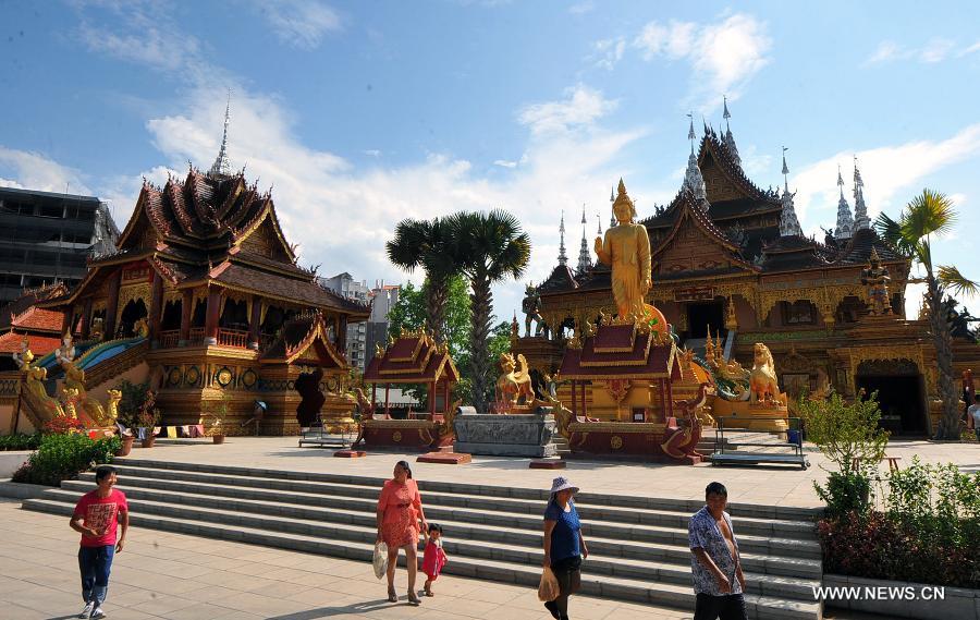 Tourists visit the Zongfo Temple in Jinghong of Xishuangbanna Prefecture in southwest China's Yunnan Province, May 16, 2013. The Zongfo Temple, which covers an area of more than 3,000 square meters and has a history of over 1,000 years, has seen completion of its overhaul and is now open free to the public. (Xinhua/Chen Haining) 