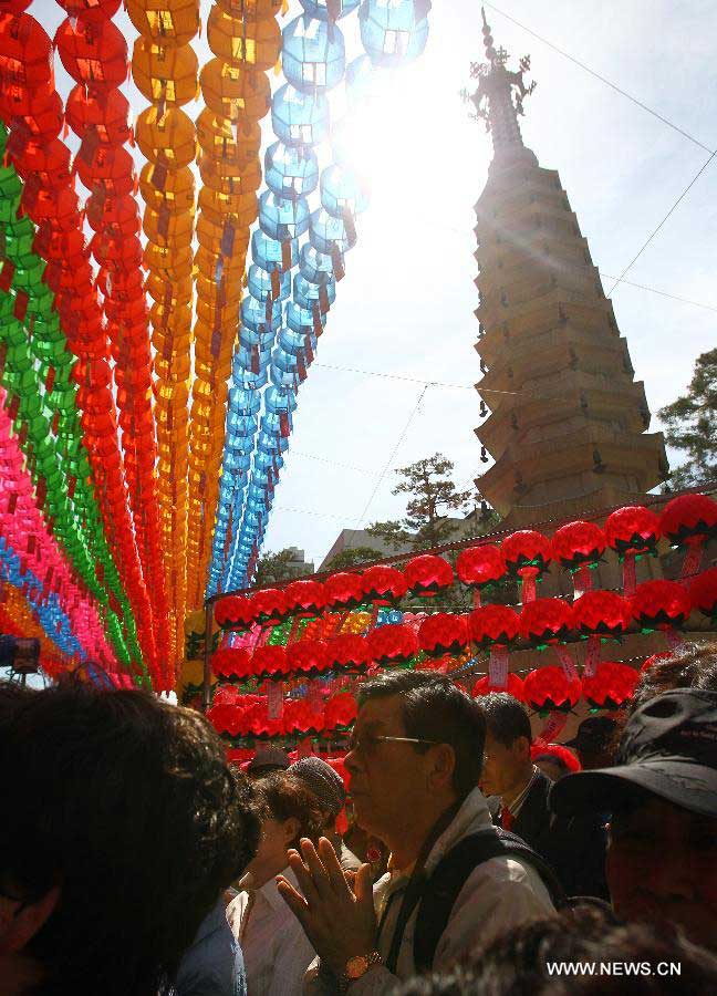 South Korean Buddhists pray during a service to celebrate the 2,557th birthday of Buddha at Chogye Temple in Seoul, South Korea, May 17, 2012. Buddha's birthday, falling on May 17 this year, is one of the most important public holidays in South Korea. (Xinhua/Yao Qilin)