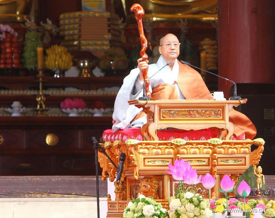 A South Korean Buddhist monk prays during a service to celebrate the 2,557th birthday of Buddha at Chogye Temple in Seoul, South Korea, May 17, 2012. Buddha's birthday, falling on May 17 this year, is one of the most important public holidays in South Korea. (Xinhua/Yao Qilin)