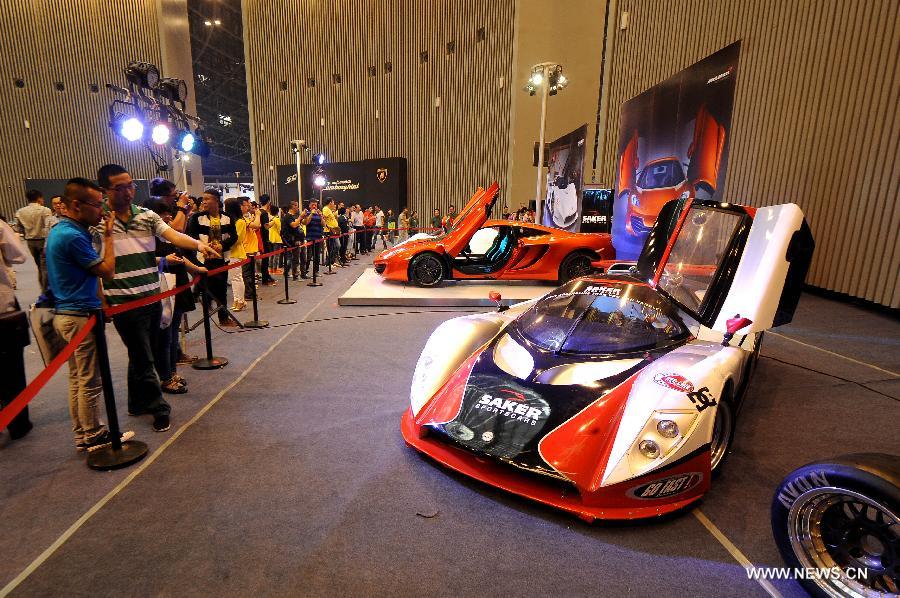 Visitors view a Saker sports car at the 2013 China (Taiyuan) International Automobile Exhibition in Taiyuan, capital of north China's Shanxi Province, May 17, 2013. Some 400 vehicles of 63 brands were taken to the auto show here, which kicked off on May 16. (Xinhua/Fan Minda) 