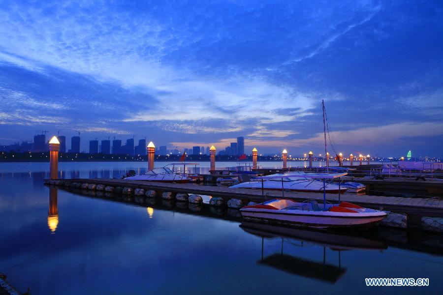 Lights of a water transportation base beacon at sunset in Rizhao, east China's Shandong Province, May 16, 2013. (Xinhua/Li Xiaolong) 